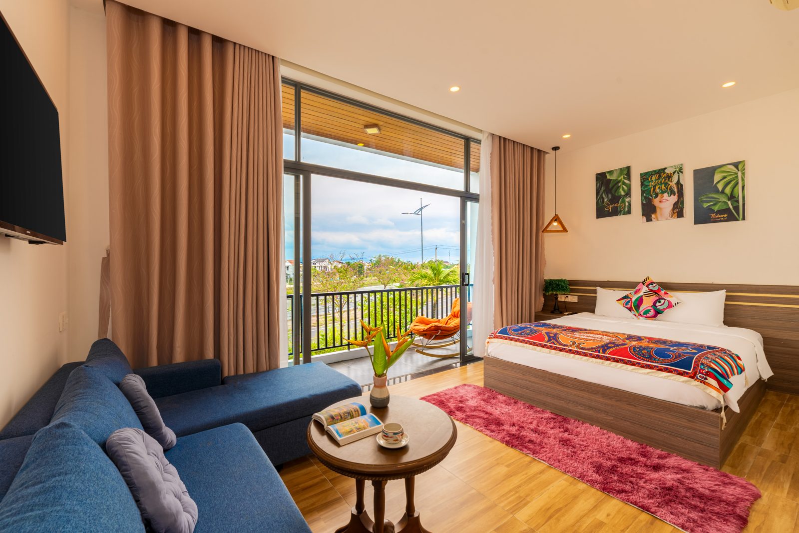 Bedroom with blue sofa and balcony doors