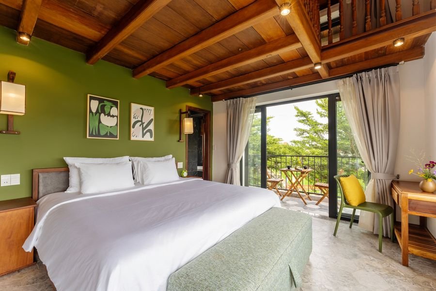 Bedroom with olive-green wall, timber ceiling and balcony