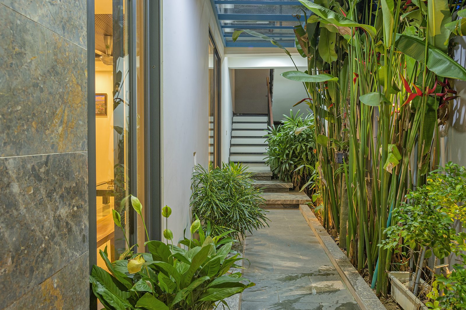 Garden path lined with heliconia leading to the villas