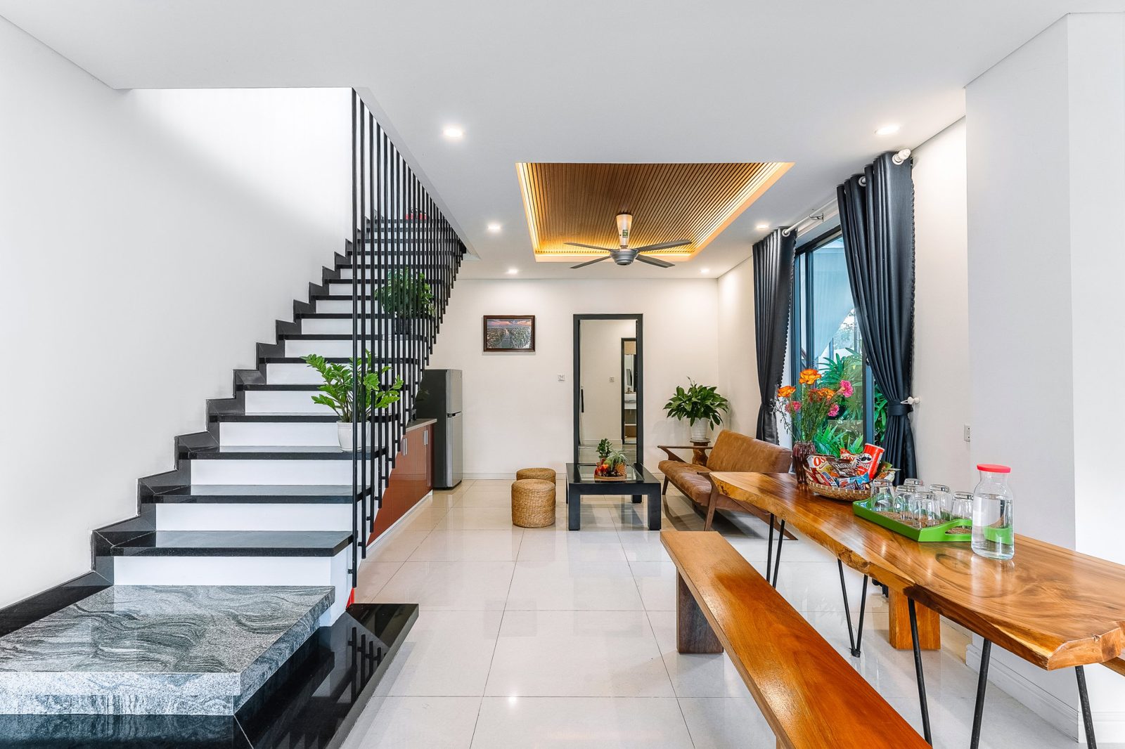 Open living and dining space with a black staircase