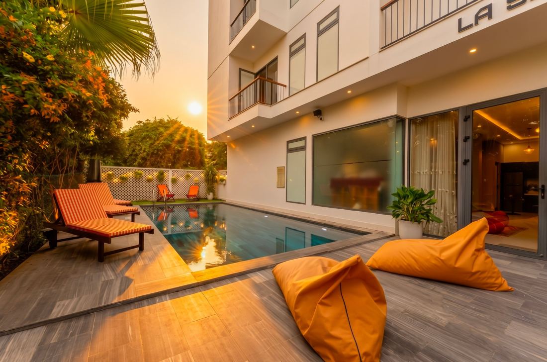 La Senarata Villa pool at sunset with loungers and orange bean bags
