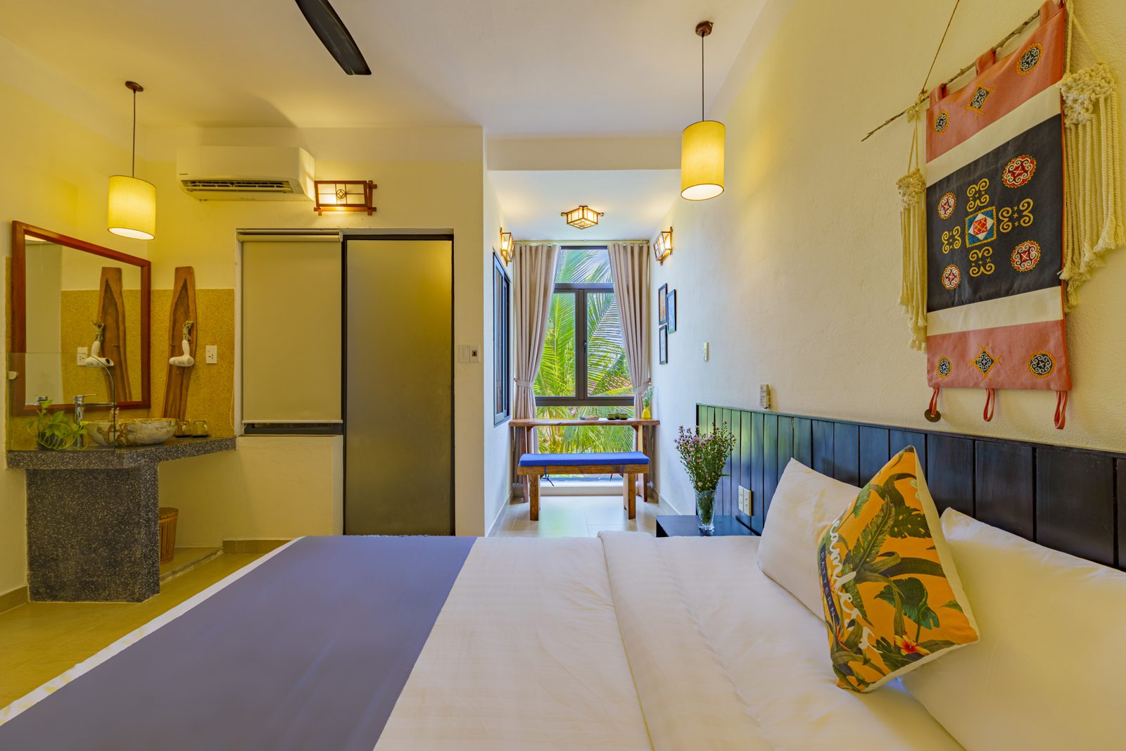 Bedroom with patchwork wall hanging and en-suite