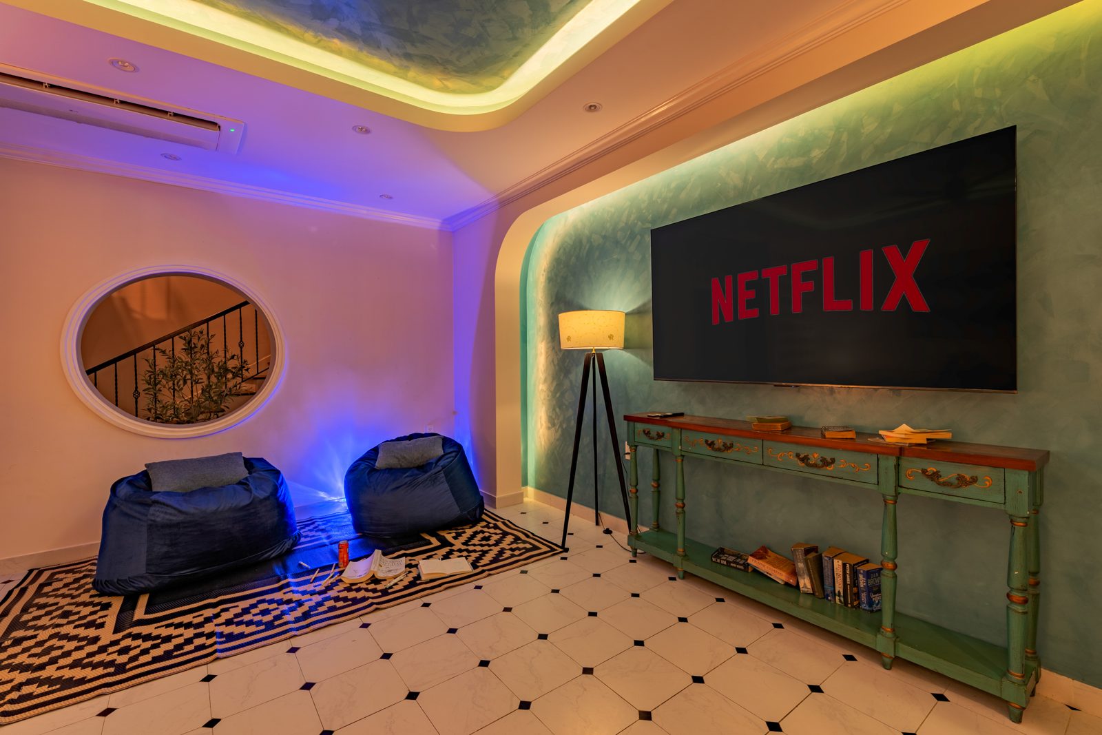 Movie room with Netflix screen, bean bags and a round window