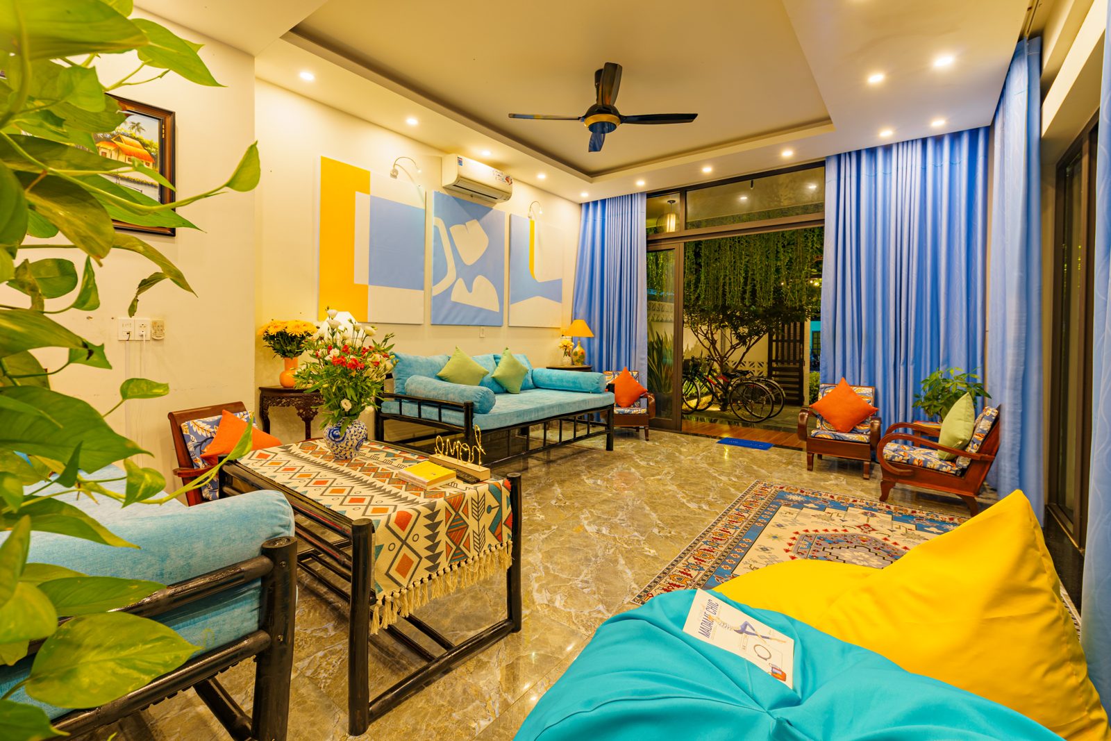 Living room with teal sofa, blue curtains and bean bags