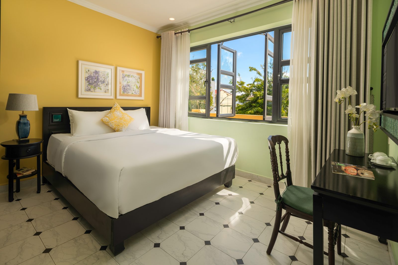 Mustard bedroom with a desk by the window