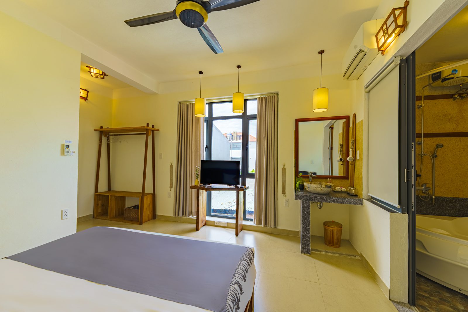 Bedroom with ceiling fan, wardrobe rail and glass bathroom
