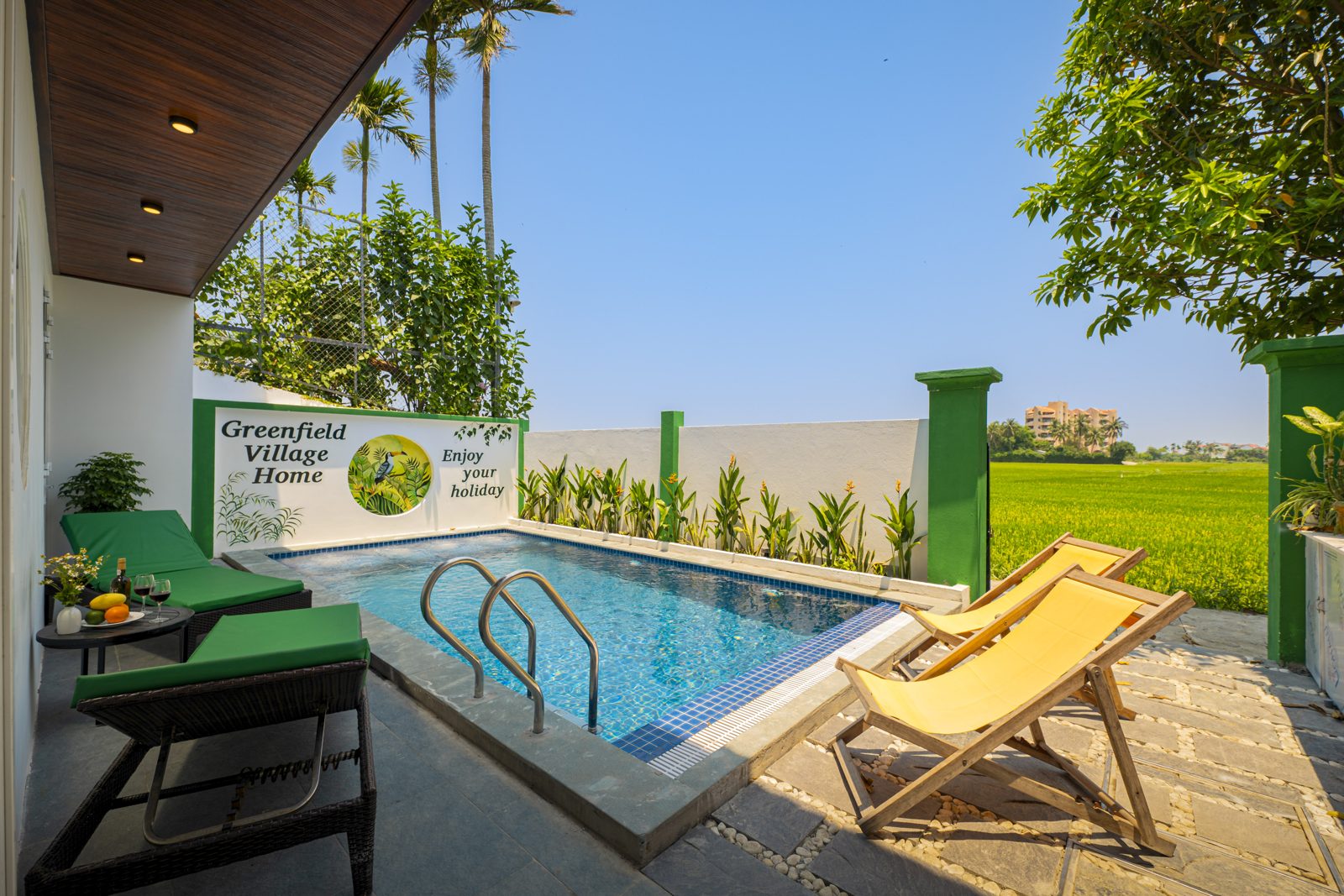 Greenfield Villa pool opening onto rice fields