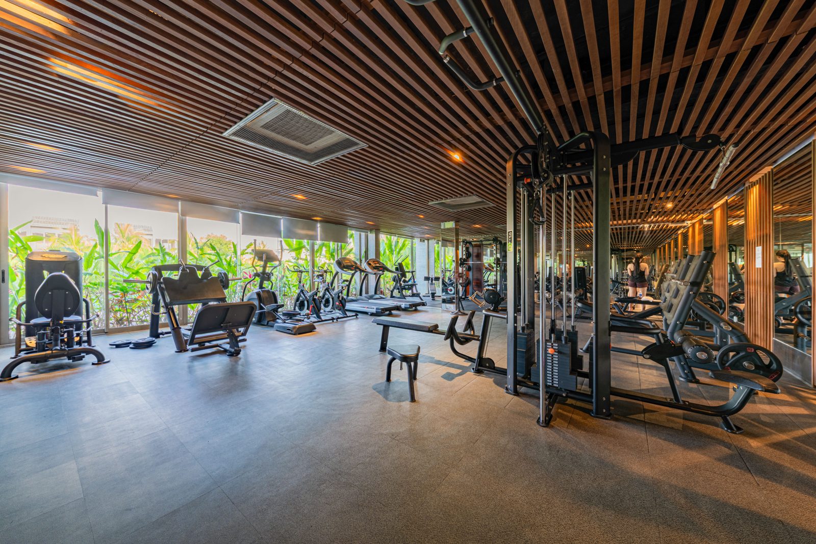 Residents' gym with timber slat ceiling and garden windows