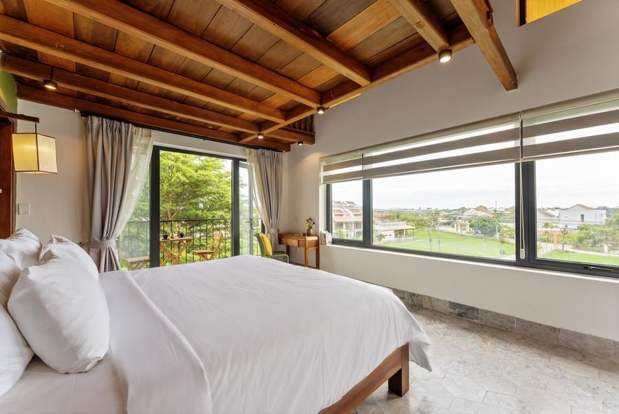 Family room with timber ceiling and wide window over the paddies