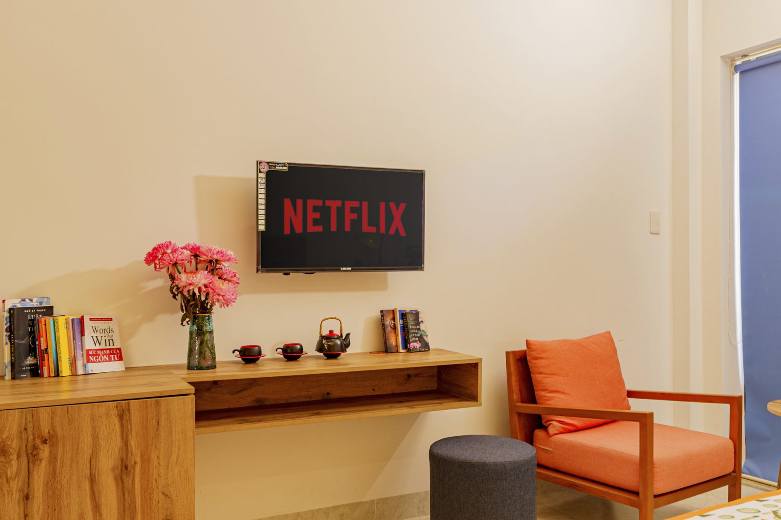 Desk with books, flowers and Netflix on the TV