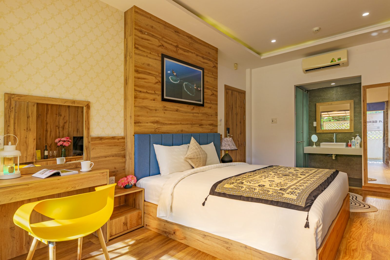 Bedroom with yellow chair at a desk and wood-panelled wall
