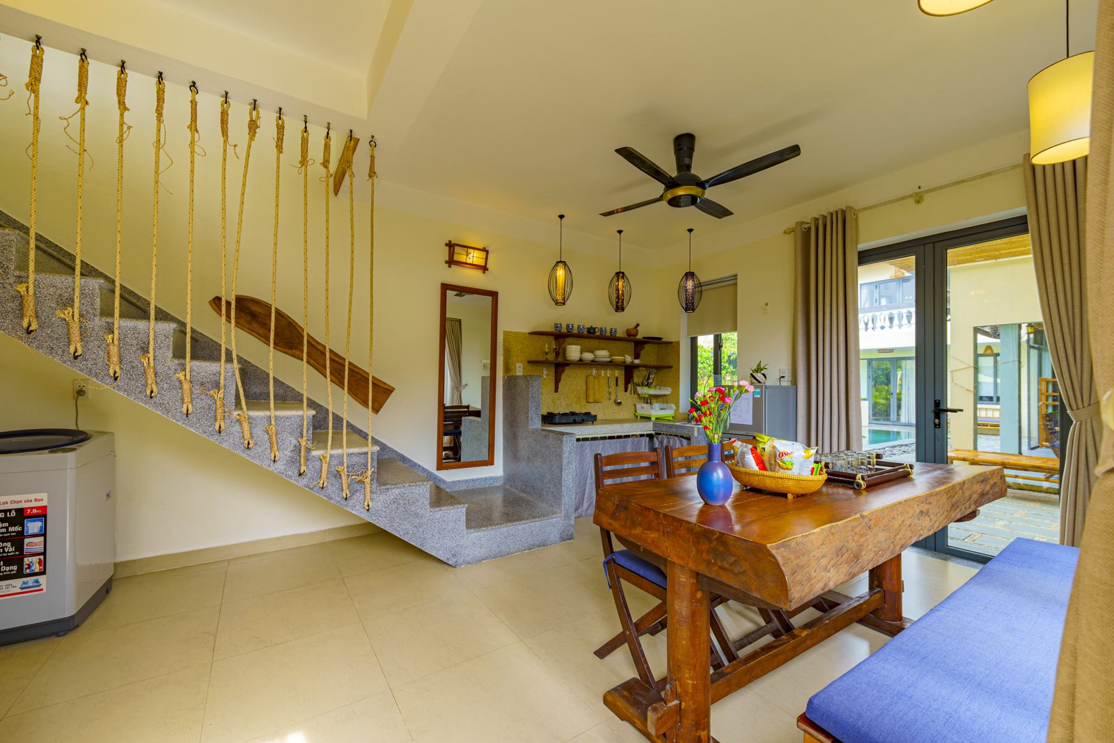 Living and dining room with rope-rail staircase and kitchen