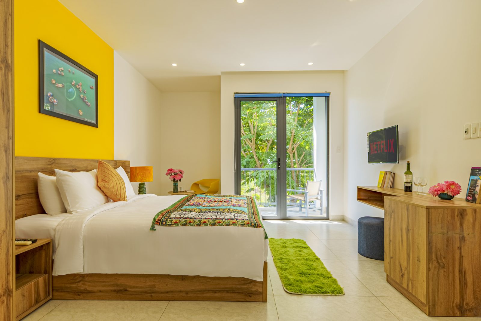 Bedroom with green rug and balcony doors