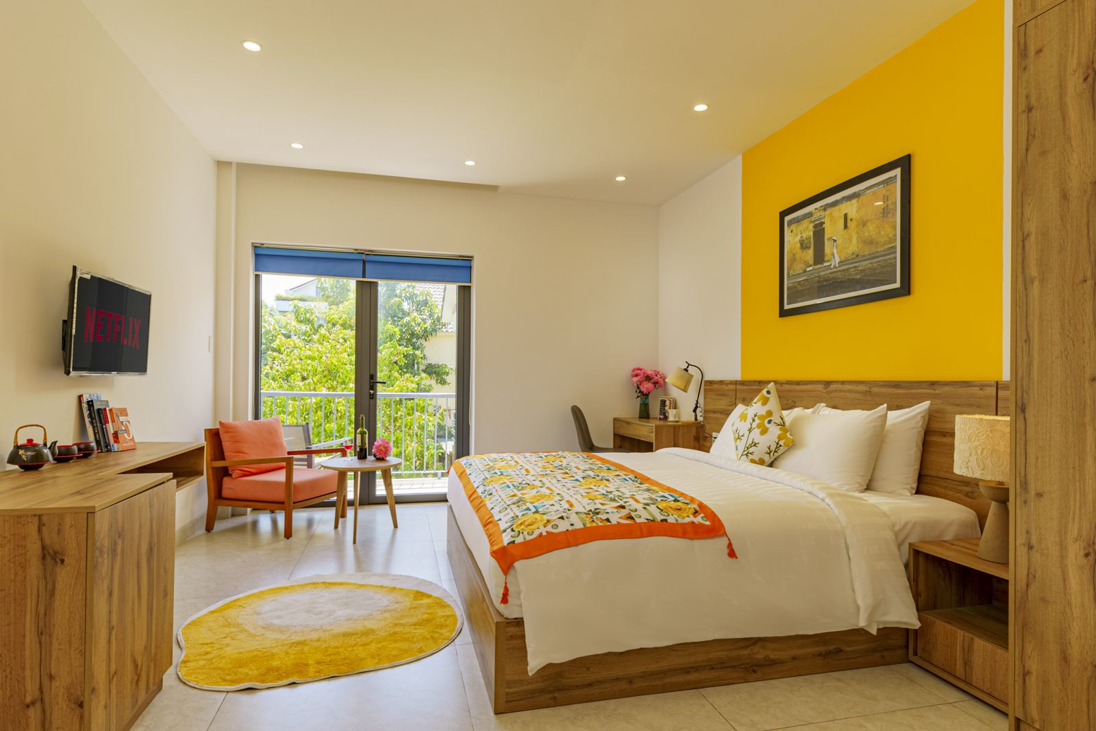 Bedroom with orange armchair and window over the trees