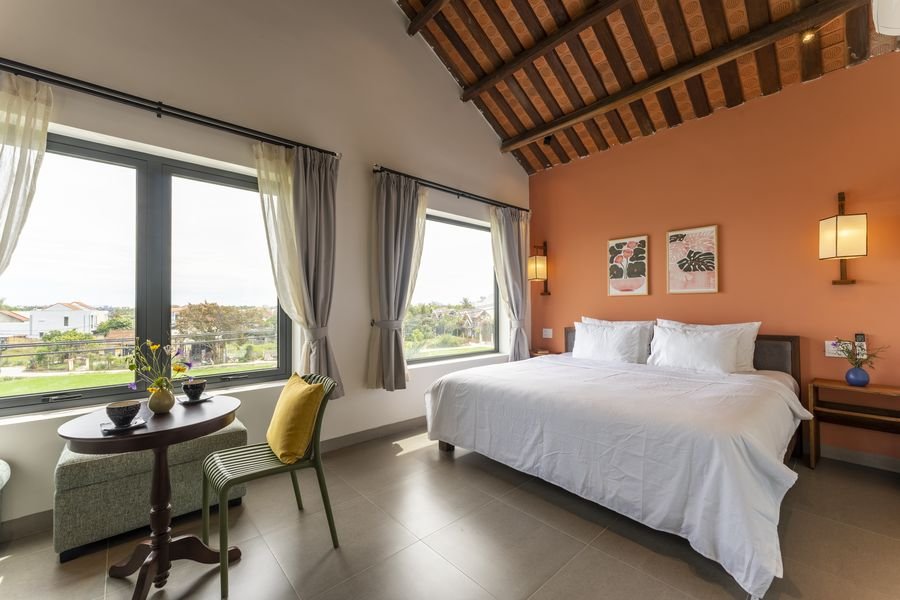 Terracotta-walled bedroom with windows on two sides